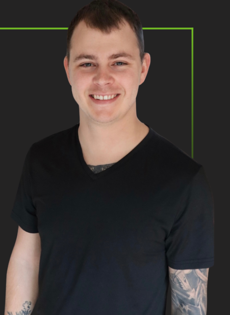 A man with a tattoo on his arm is wearing a black shirt