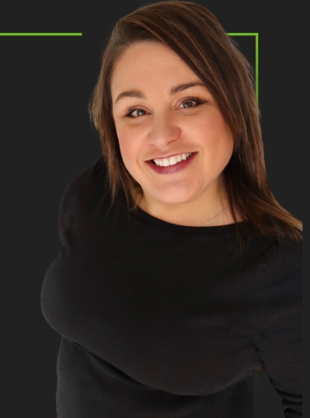 A woman in a black shirt is smiling for the camera