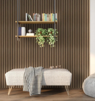 A light-colored upholstered bench with a patterned throw blanket sits before a vertical wood-slat wall with hanging shelves.