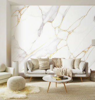 A minimalist living room with a white and gold marble accent wall, a light-toned sofa, a round table, and a plush rug.