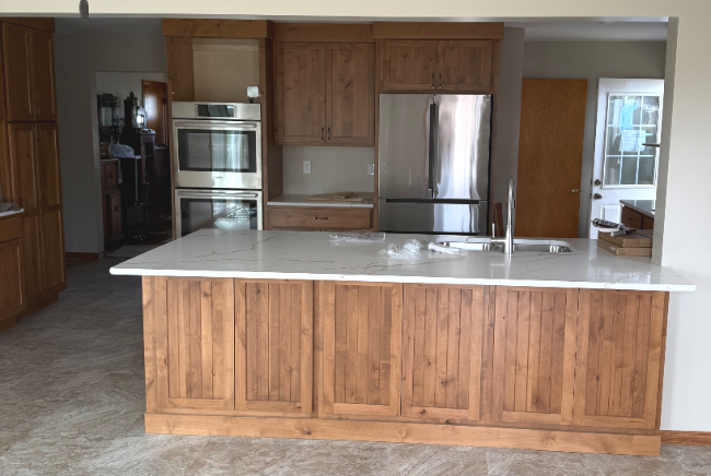 A kitchen with stainless steel appliances and wooden cabinets