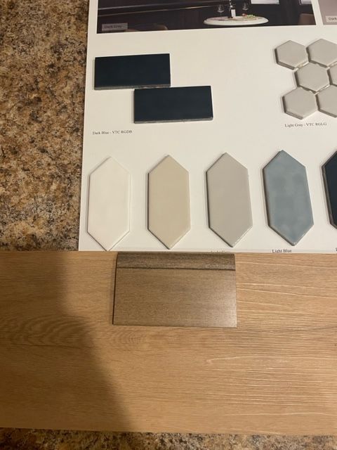 A bunch of tiles are sitting on top of a wooden table.