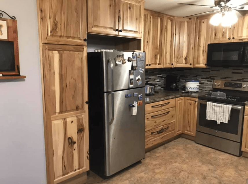 A kitchen with stainless steel appliances and wooden cabinets