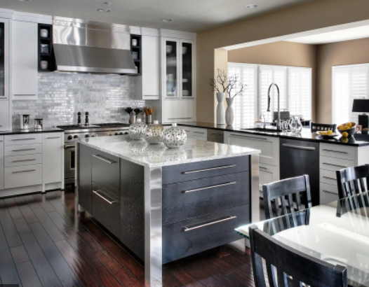 A kitchen with stainless steel cabinets and a large island