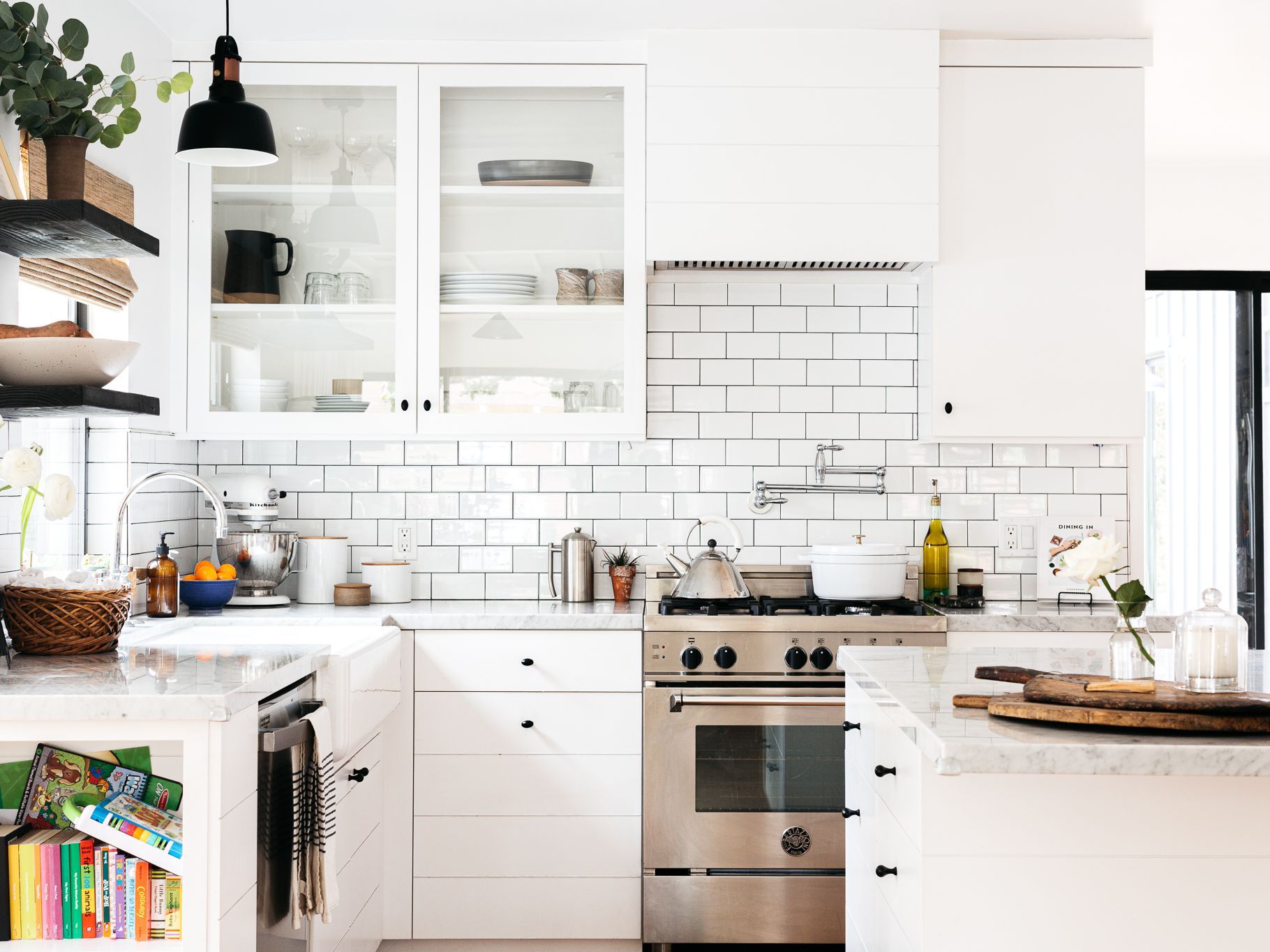 A kitchen with white cabinets and stainless steel appliances.
