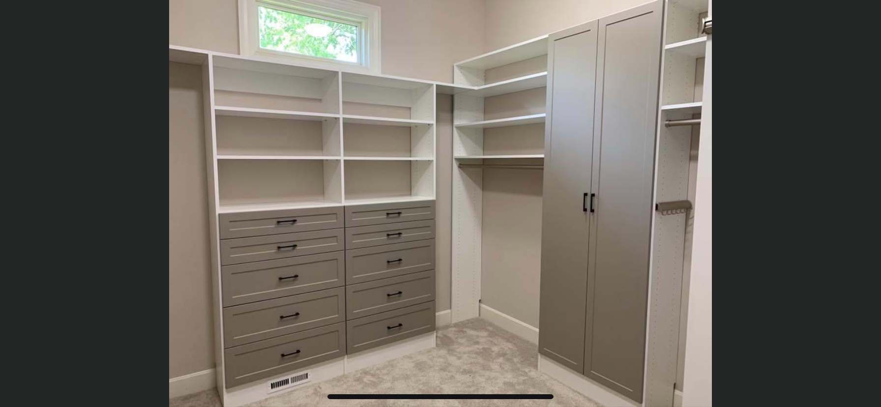 A walk in closet with lots of shelves and drawers.