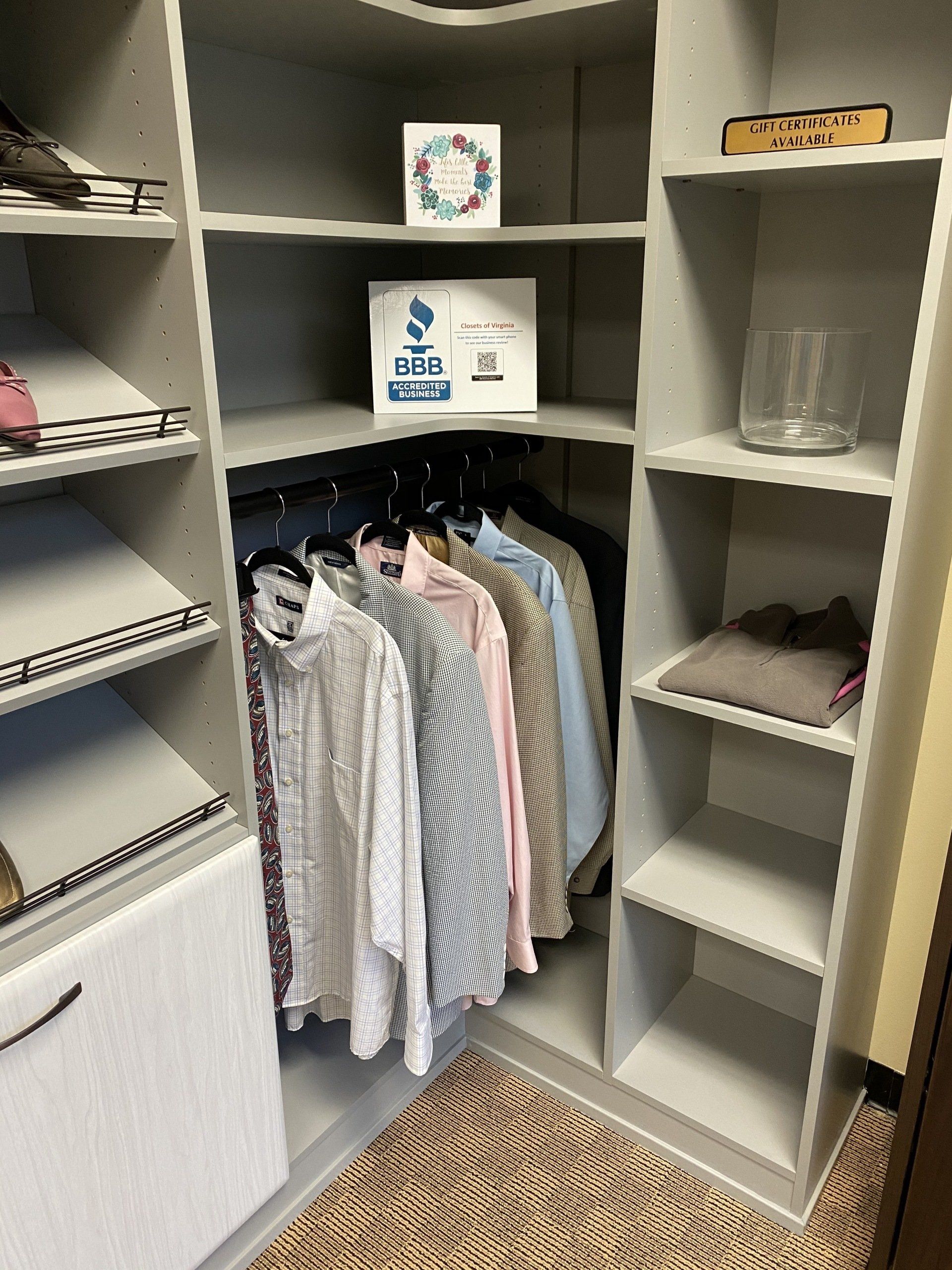 A walk in closet filled with clothes and shelves.