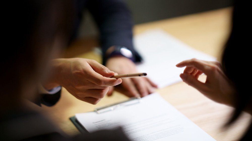 Handing A Pen To The Client — Dos Palos, CA — Linneman Law
