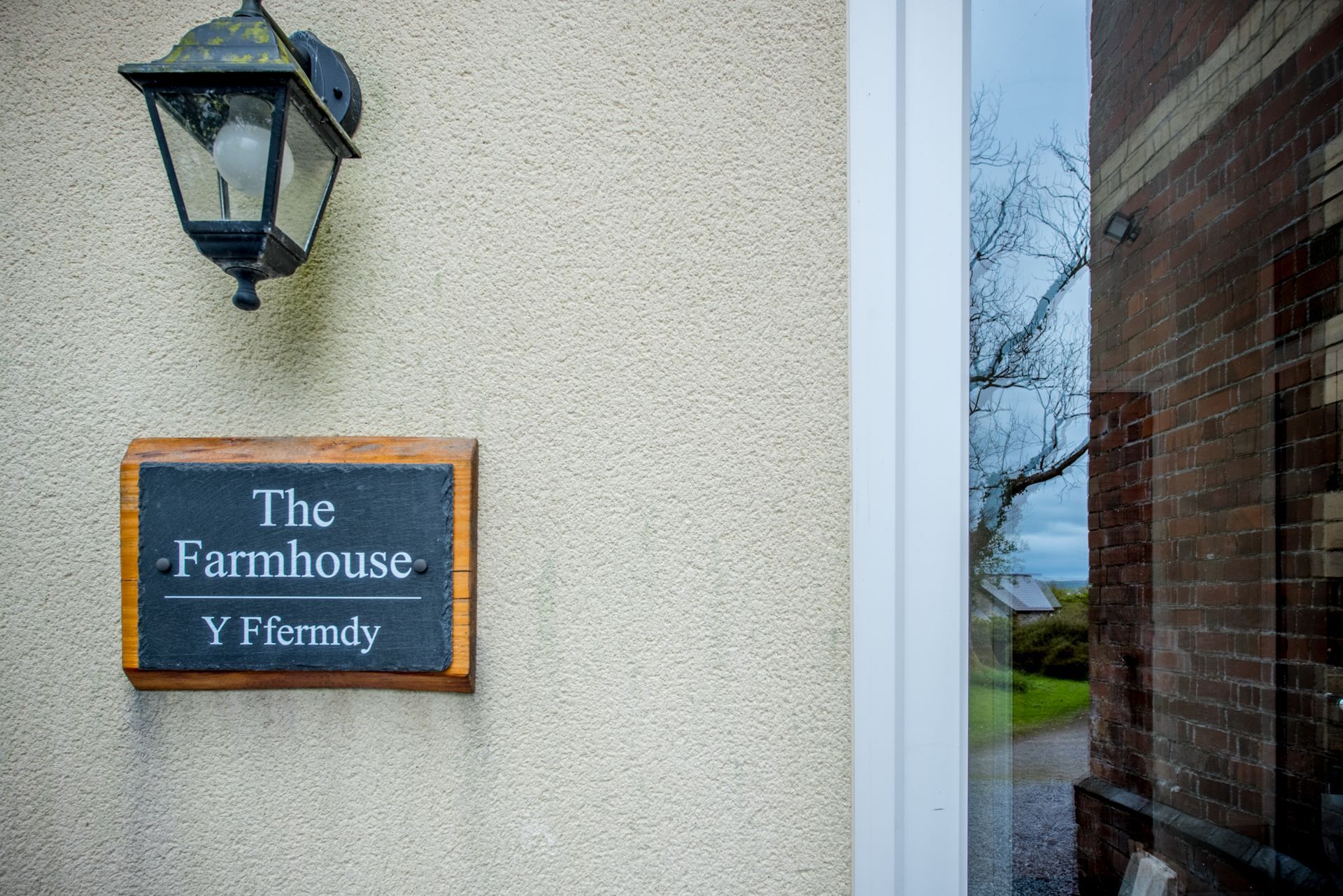 Front door and name sign for The Farmhouse at Green Grove Barns, Carmarthenshire.