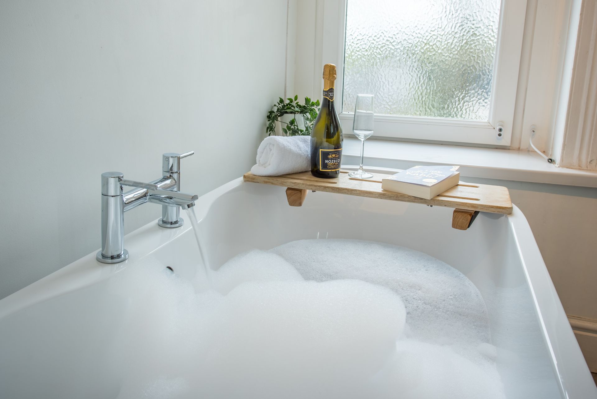 Freestanding bath with bubbles and champagne at The Farmhouse, Green Grove Barns.