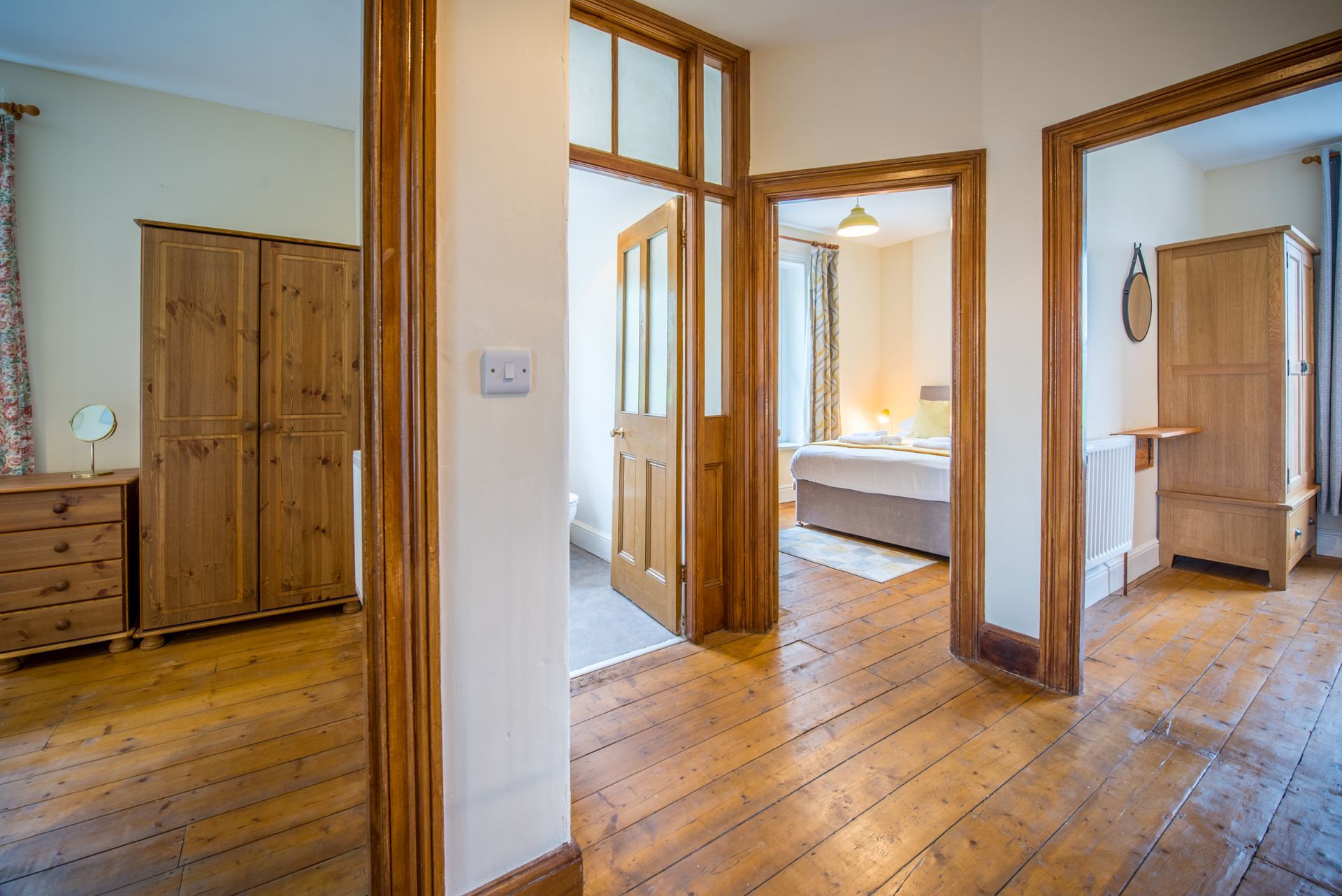 Hallway inside The Farmhouse with wooden floors and natural light.