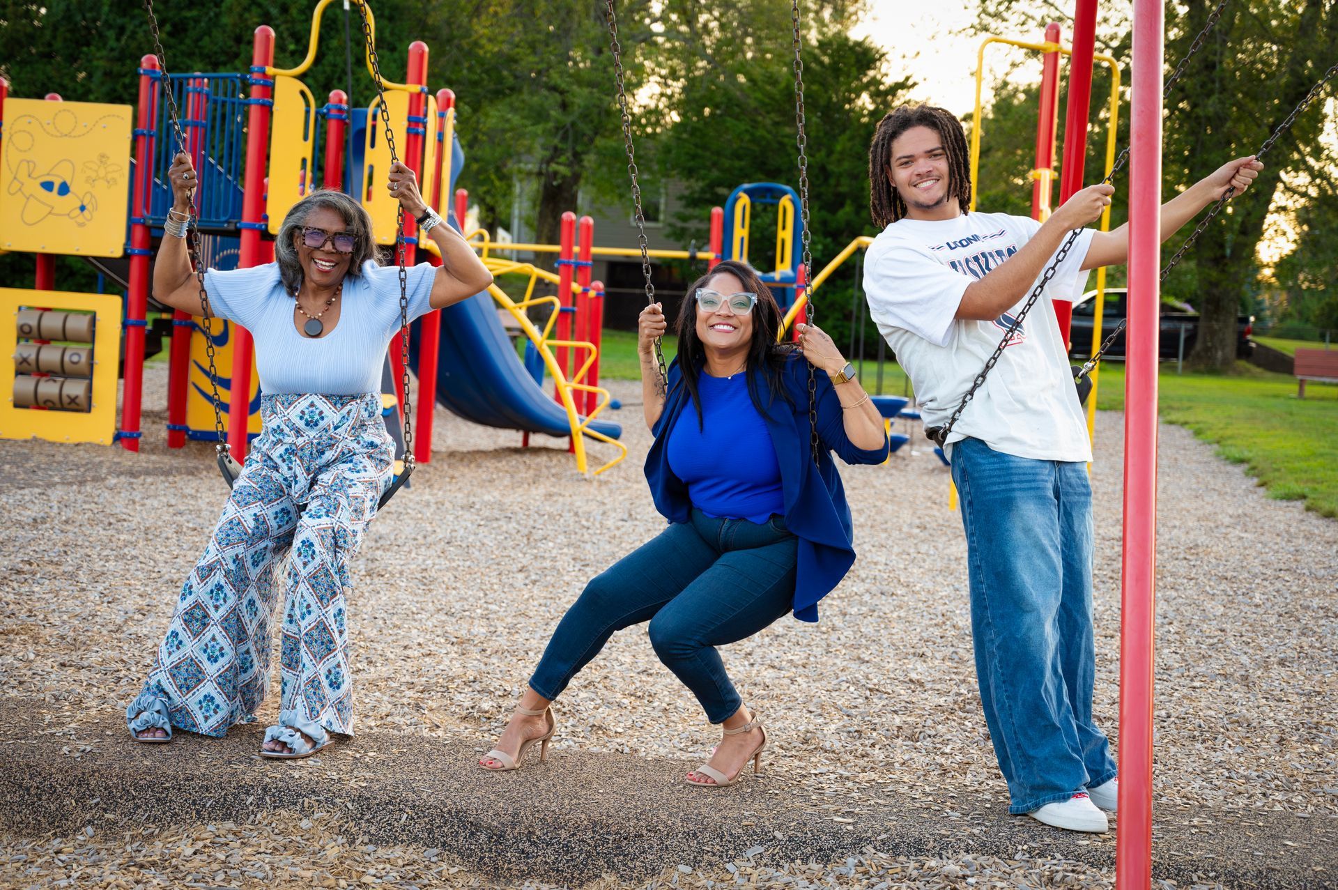 Maya Nicole, mom, and son on swingset