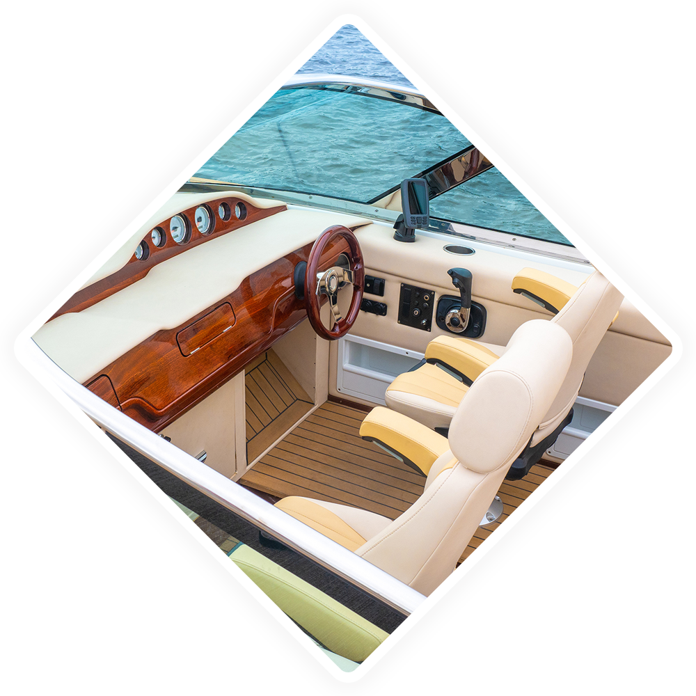 The interior of a boat with a steering wheel and seats