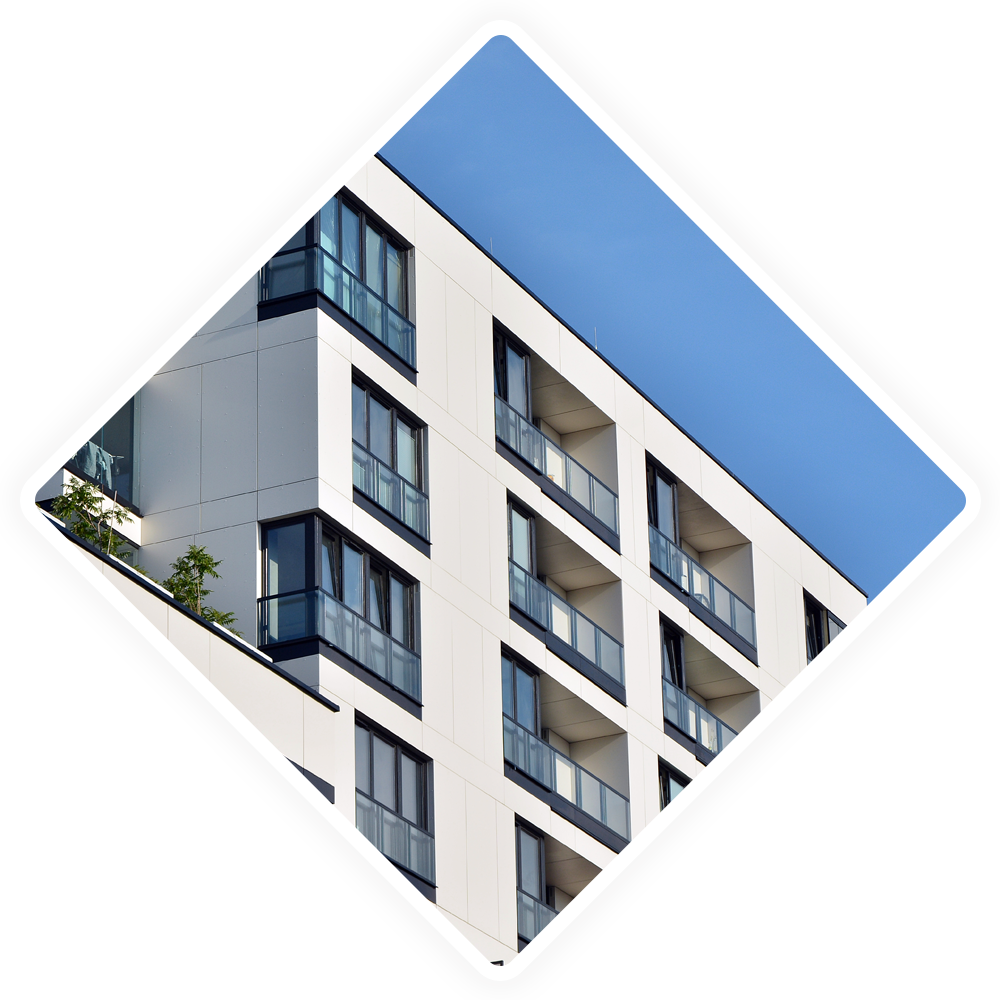 A building with a lot of windows and balconies against a blue sky