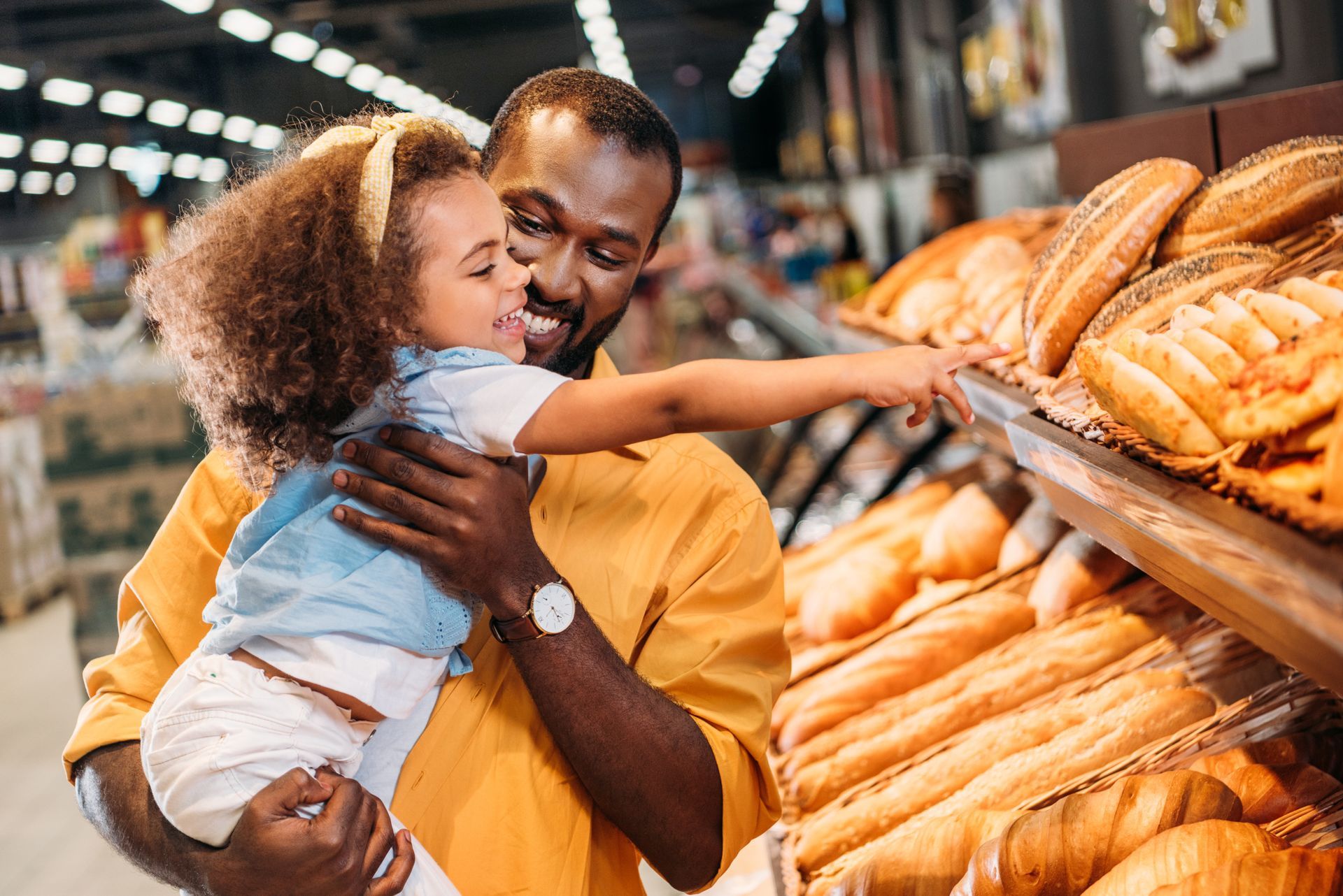 Man and daughter grocery shopping