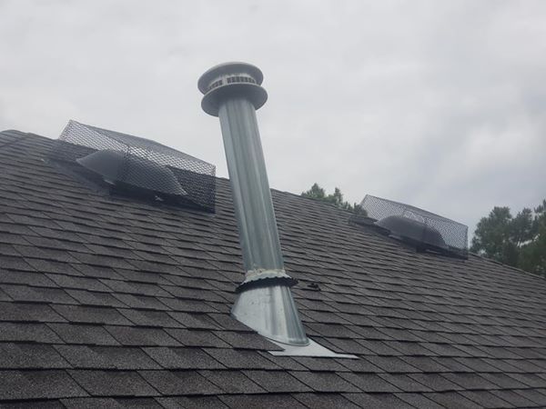 There is a chimney on the roof of a house.