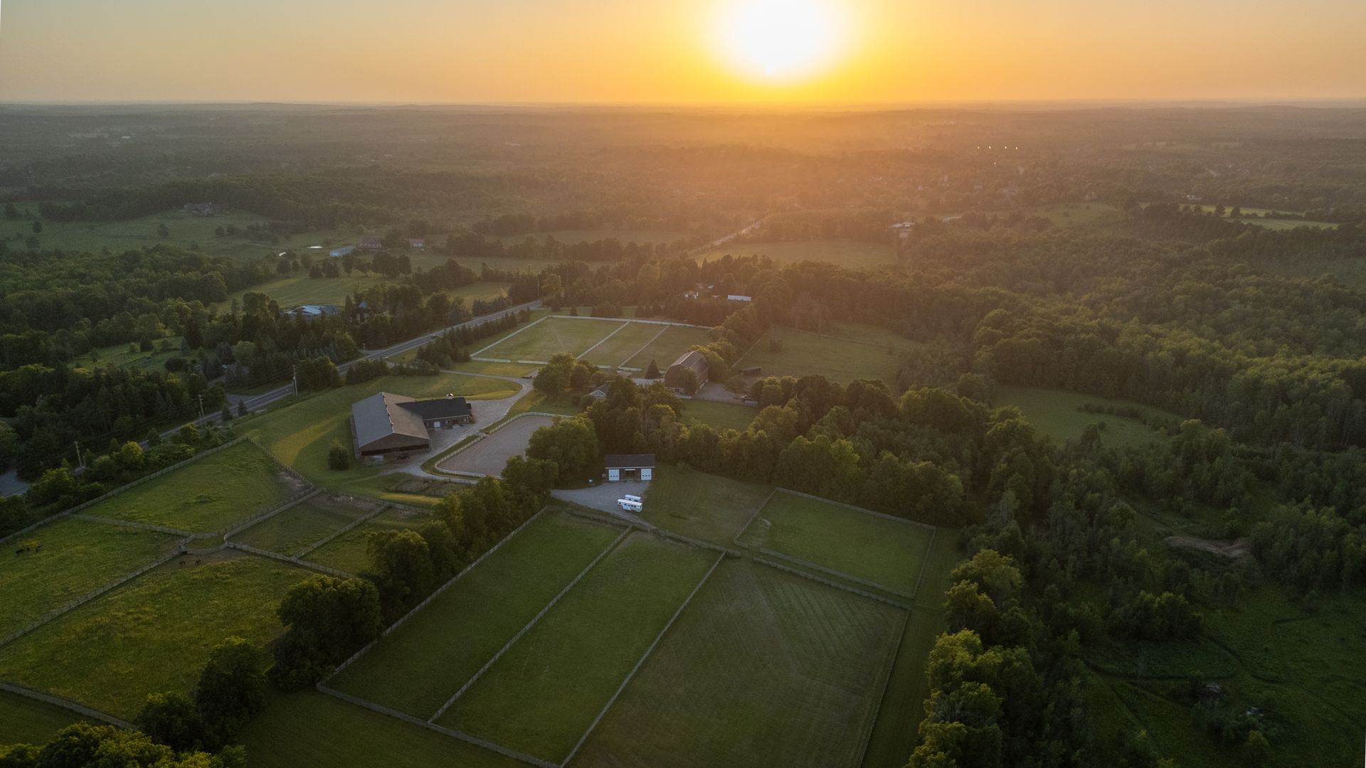 An aerial view of a soccer field at sunset.