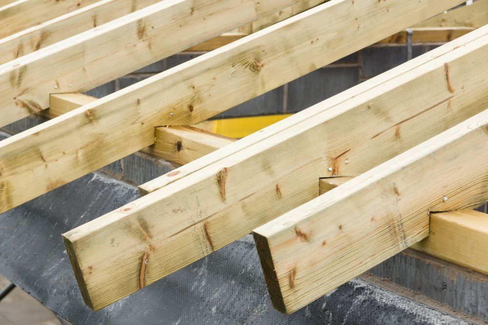 Wooden Rafters, Angled, Partially Constructed on a Gray Surface — Sly Bros in Byron Bay, NSW