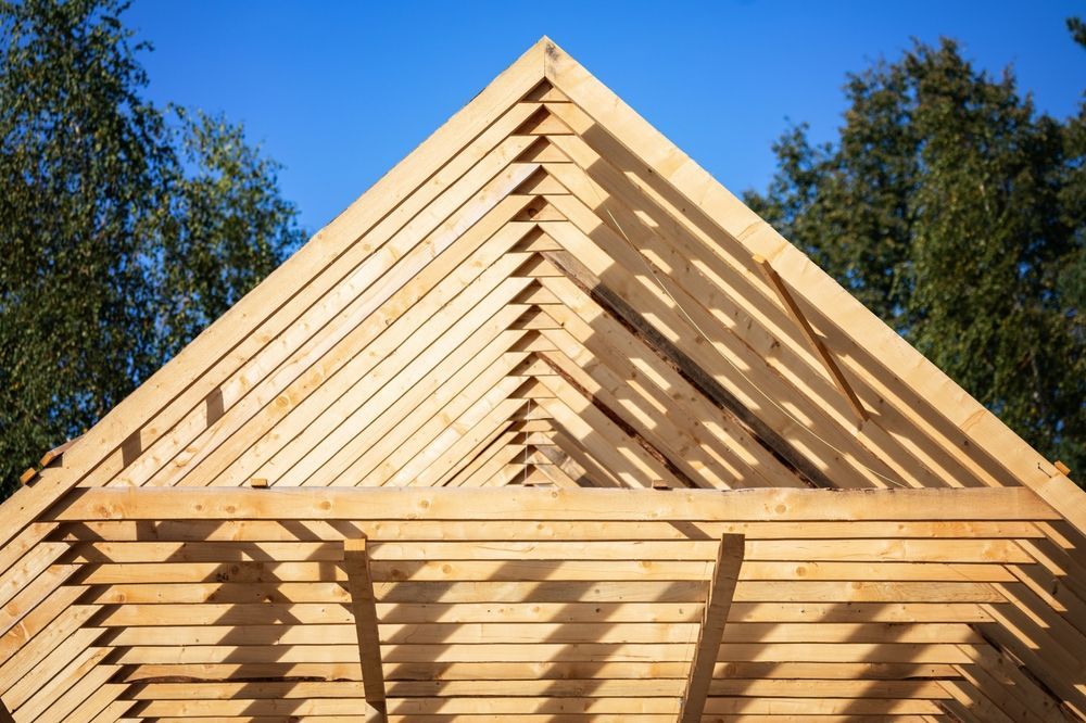 Wooden Roof Frame Construction Against a Blue Sky — Sly Bros in Casino, NSW