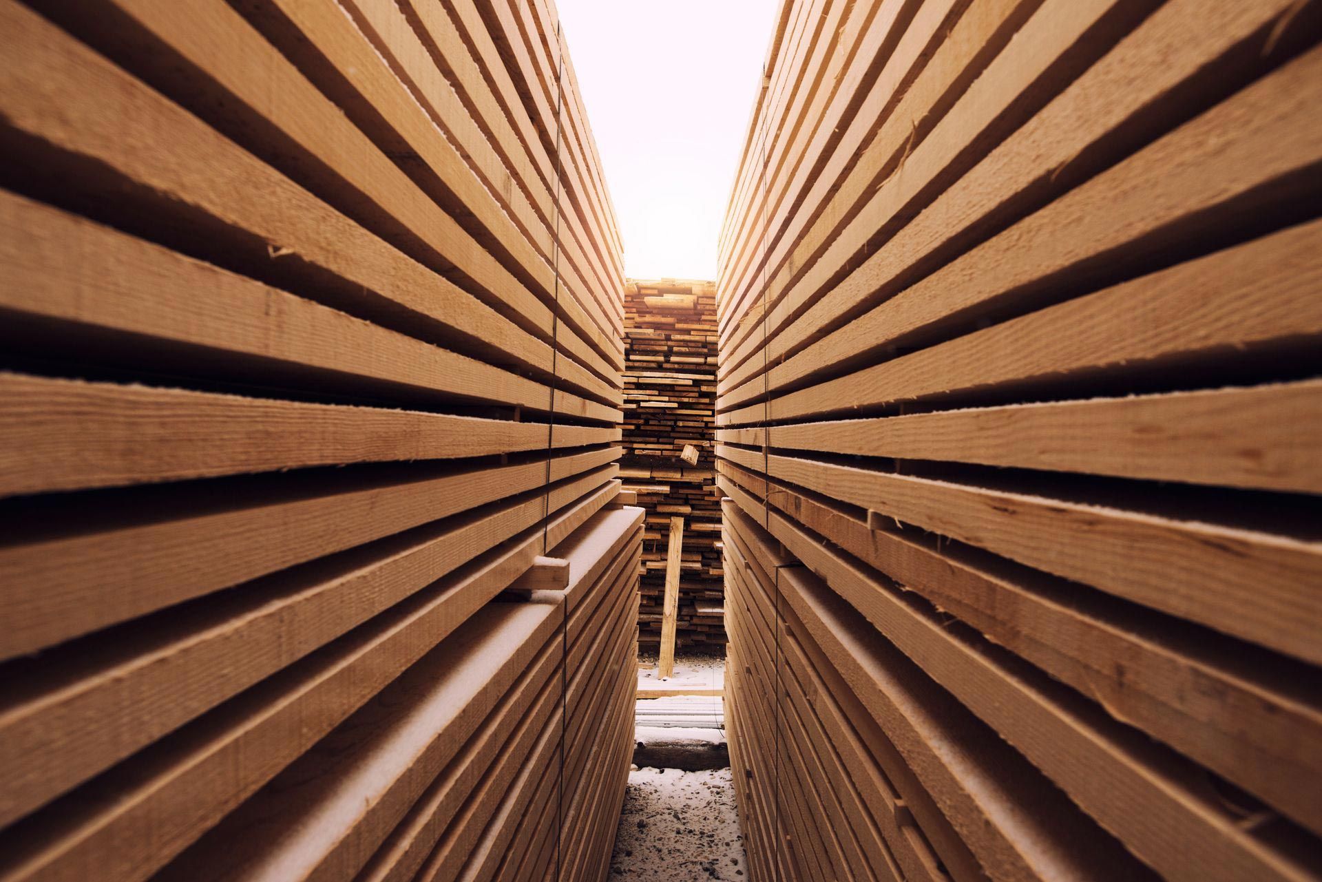 Stacks of Wooden Planks in a Lumberyard — Sly Bros in Woodburn, NSW