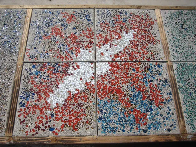 A red white and blue tile with a white arrow in the middle