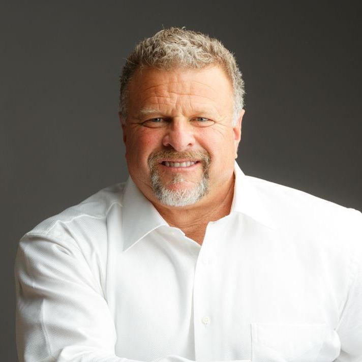 A man with a beard is wearing a white shirt