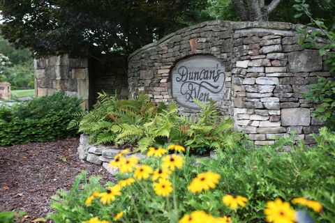 Landscape Lighting — Monument With Flowers And Plants in Knoxville, TN
