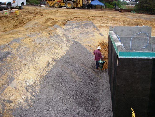 Worker next to soil and construction site — Santa Rosa, CA — Reese & Associates
