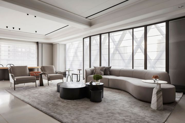 A living room with a yellow couch , a table , and a window