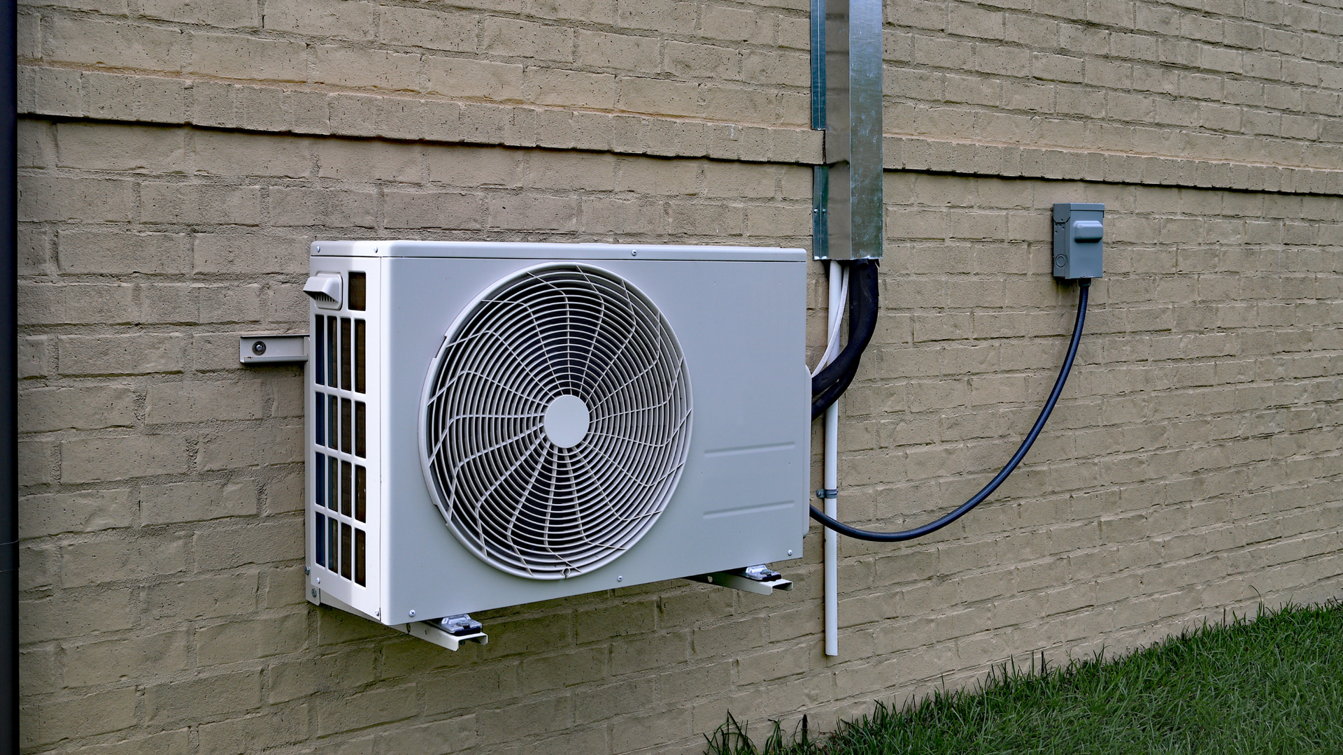 A person is cleaning an air vent with a brush.