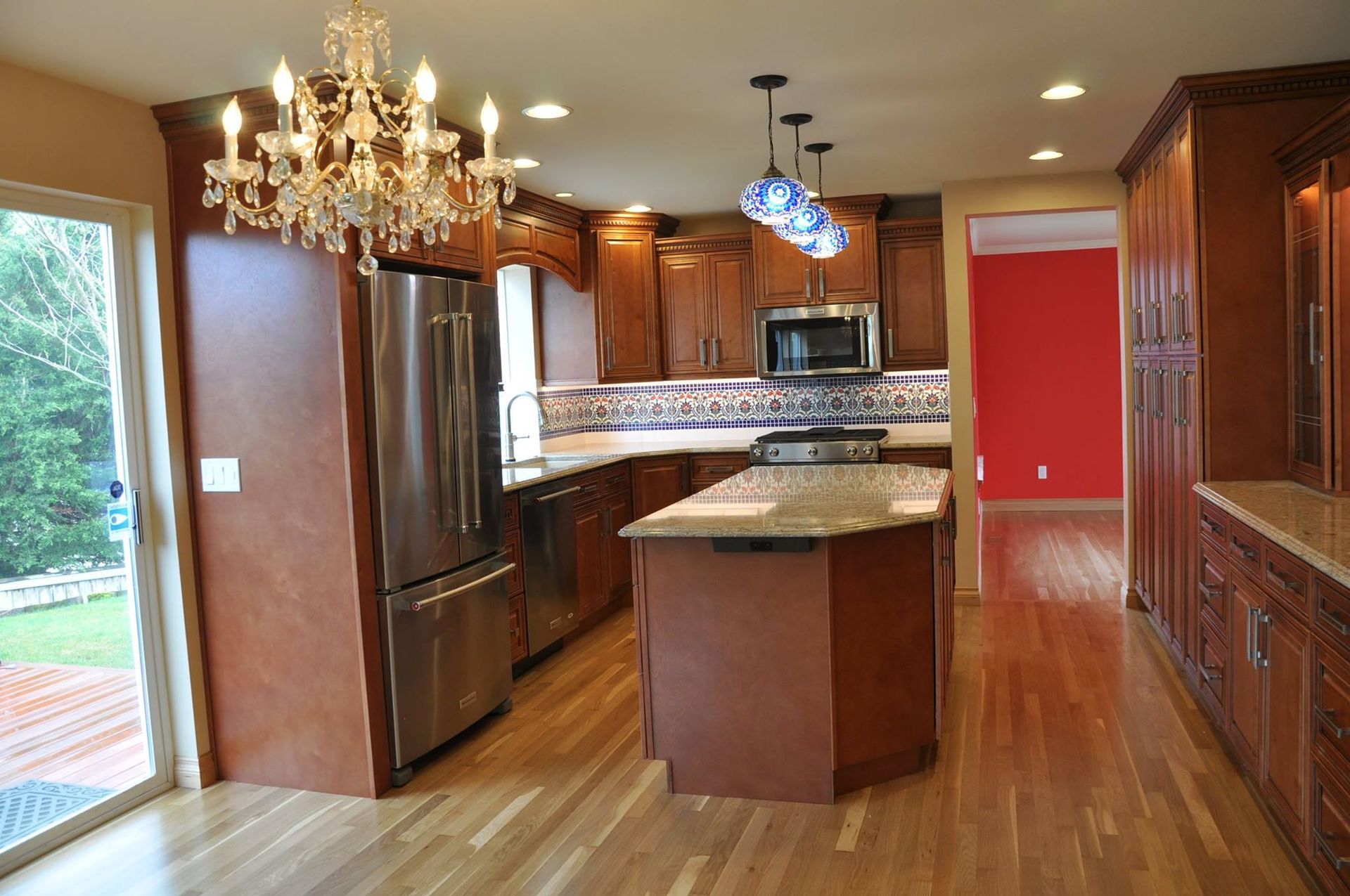 Kitchen with wood cabinets, stainless steel appliances, and a central island with a granite countertop.
