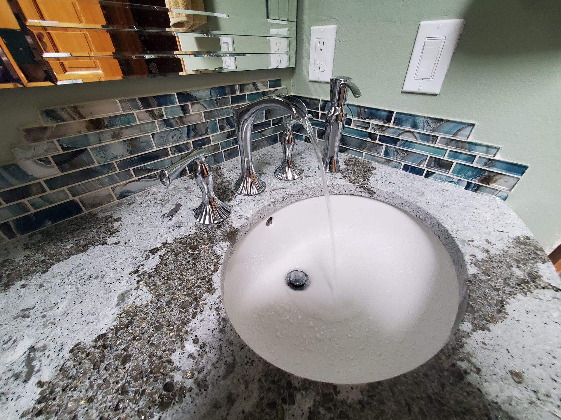 Bathroom sink with a white basin, chrome fixtures, and a granite countertop
