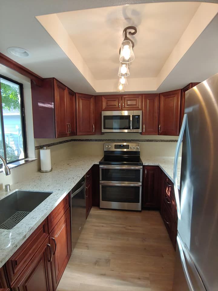 Kitchen with wood cabinets, stainless steel appliances, and light countertops.