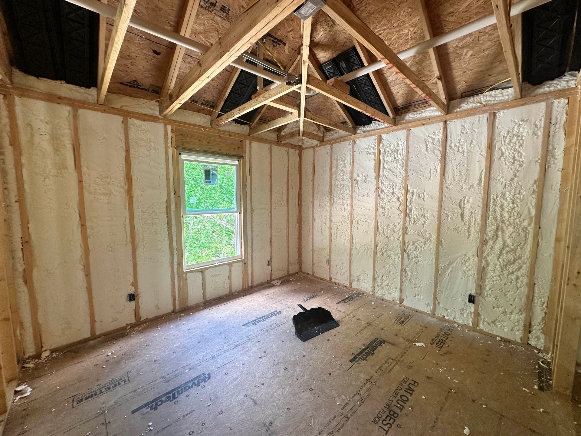 A room with foam insulation on the walls and ceiling.