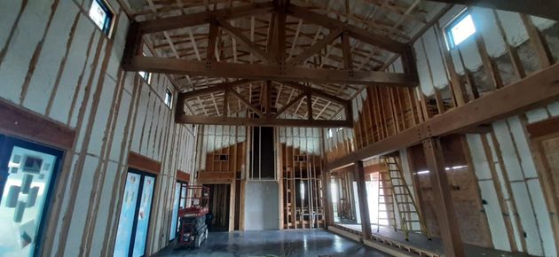 A large room with a ceiling that is being built.