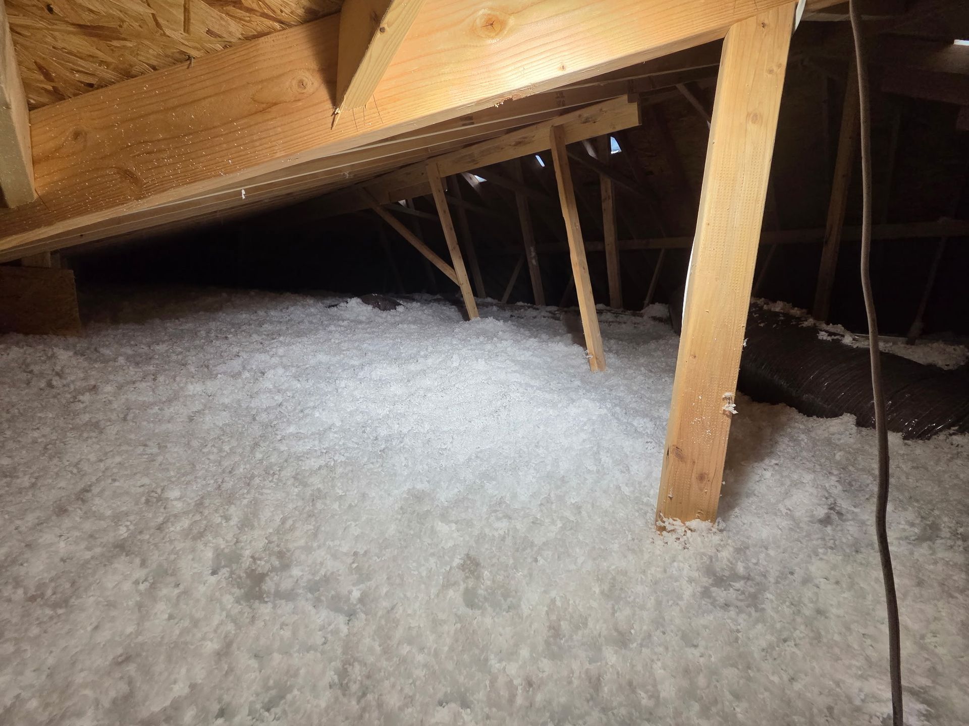 There is a lot of insulation in the attic of a house.