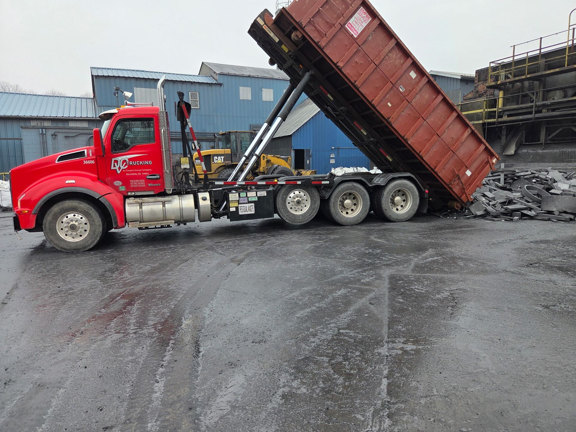 DVC roll-off truck dumps excess graphite at a facility to be repurposed.