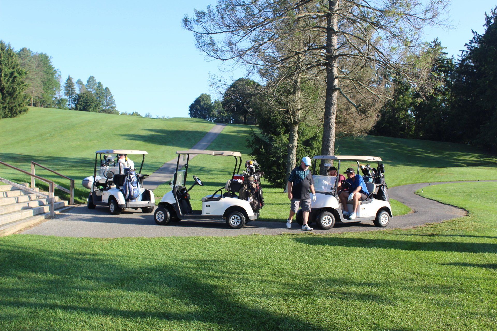 Three golf carts line up at the first hole.