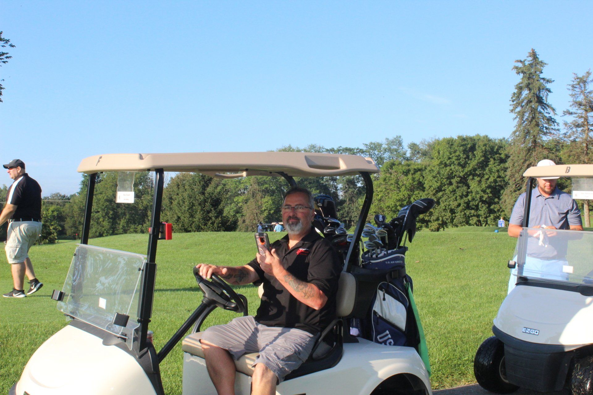 Russ Oswalt in a golf cart ready to play golf!
