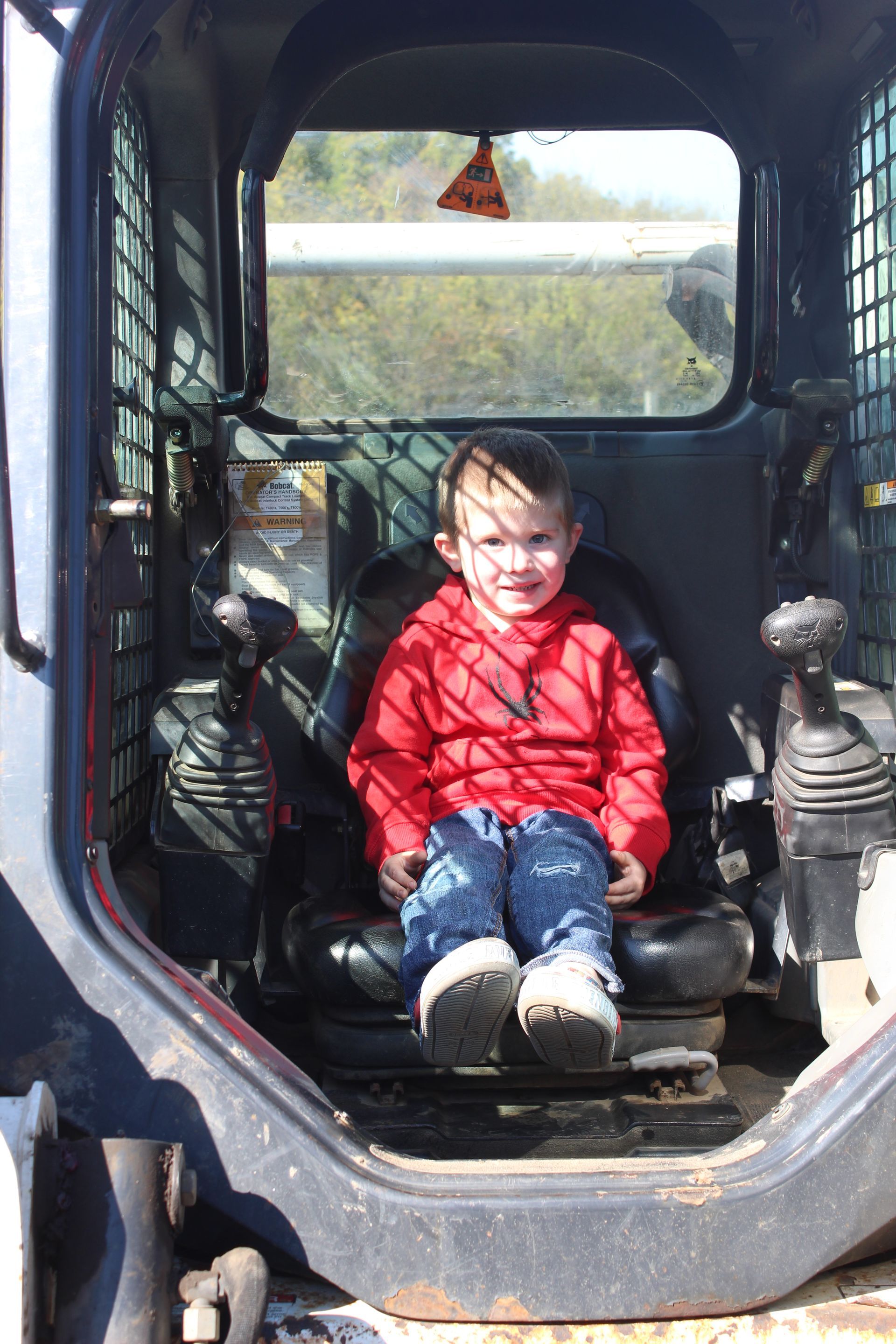 A little boy in the mini excavator!