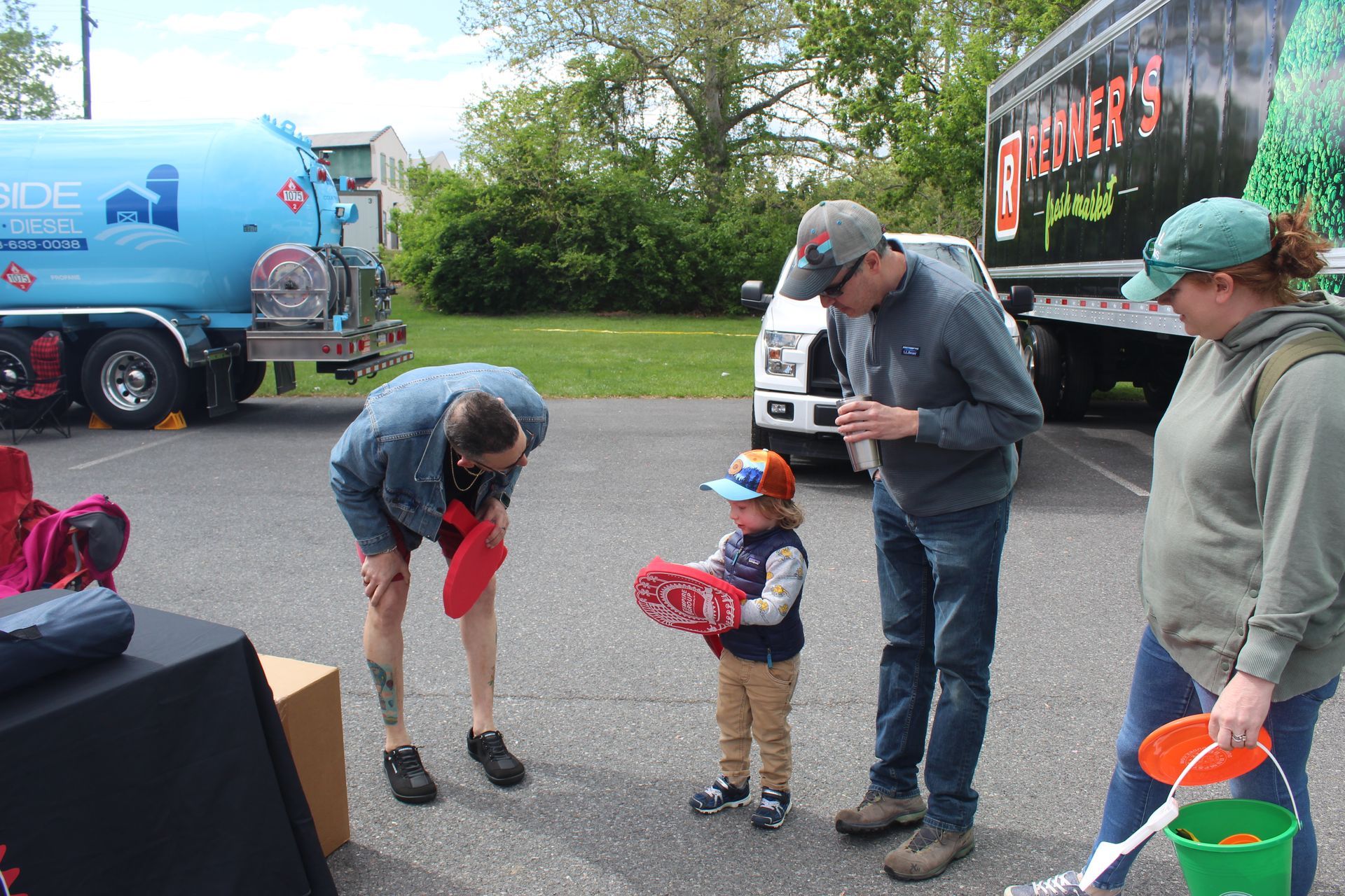 DVC's Chris Gring hands out a foam baseball bat and mitt to one of the many kids at the event.