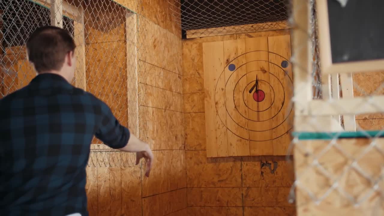 Man throwing axe at a target