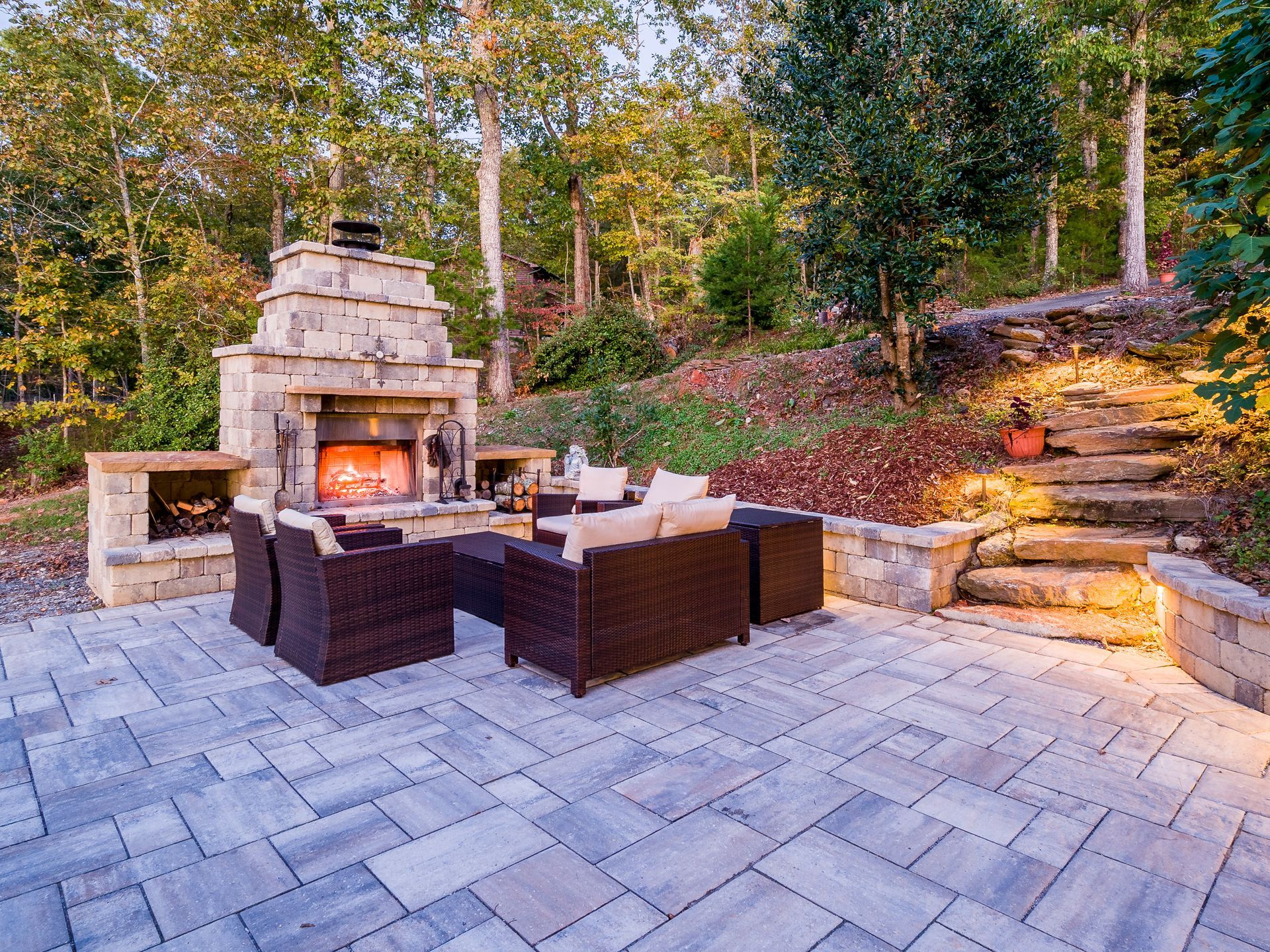 An outdoor fireplace on a patio, surrounded by comfortable seating for a cozy and inviting outdoor living space.