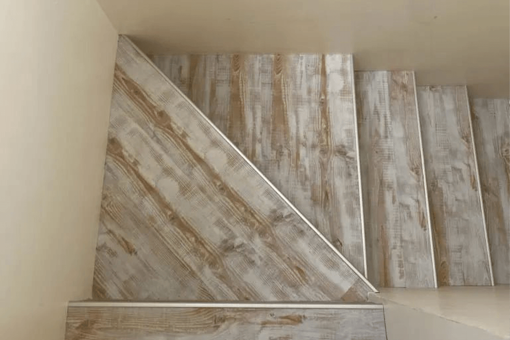 Wooden Laminate Flooring On Stairs— Flooring Supply & Installation In Laurieton, NSW