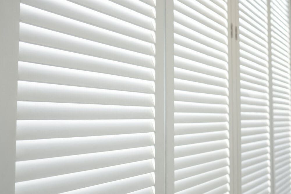A Close Up Of A Row Of White Shutters On A Window — Geoff Thompson's Independent Flooring Centre In Port Macquarie, NSW