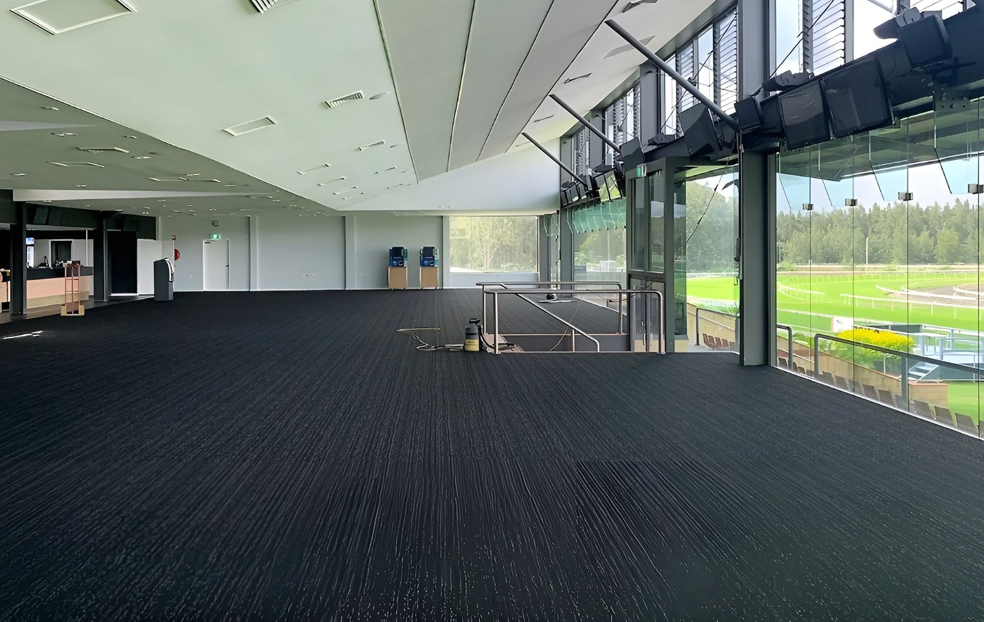 Empty Indoor with Black Carpet and Glass Window — Geoff Thompson's Independent Flooring Centre In Port Macquarie, NSW