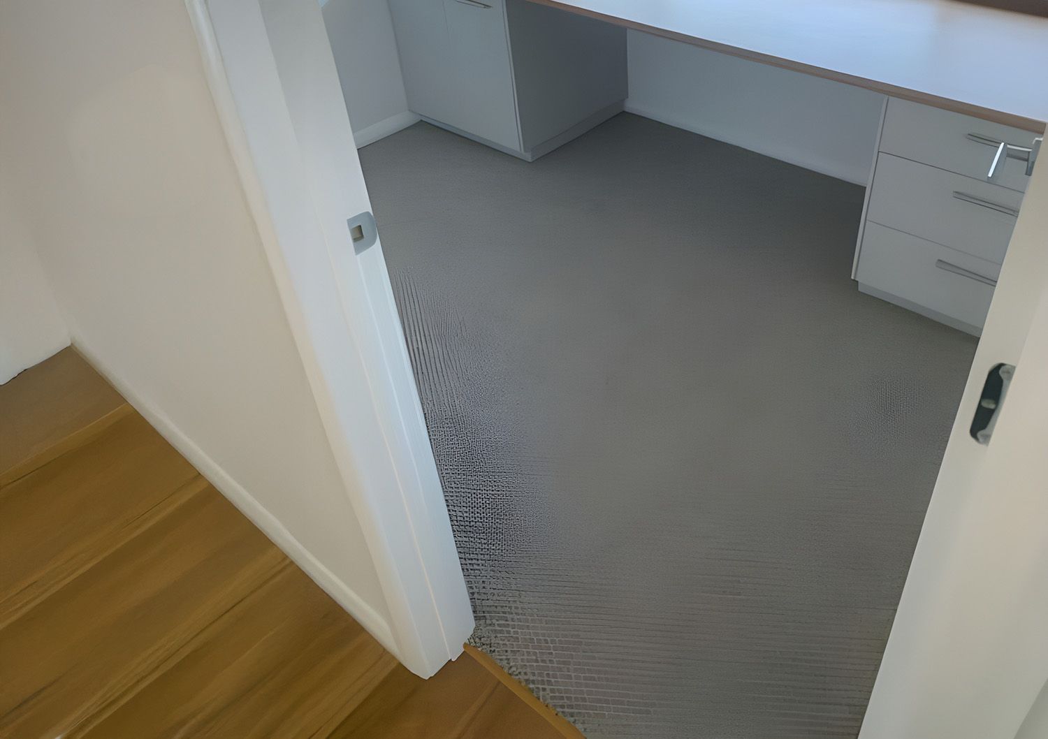 View from a Doorway Into a Room with Gray Carpet