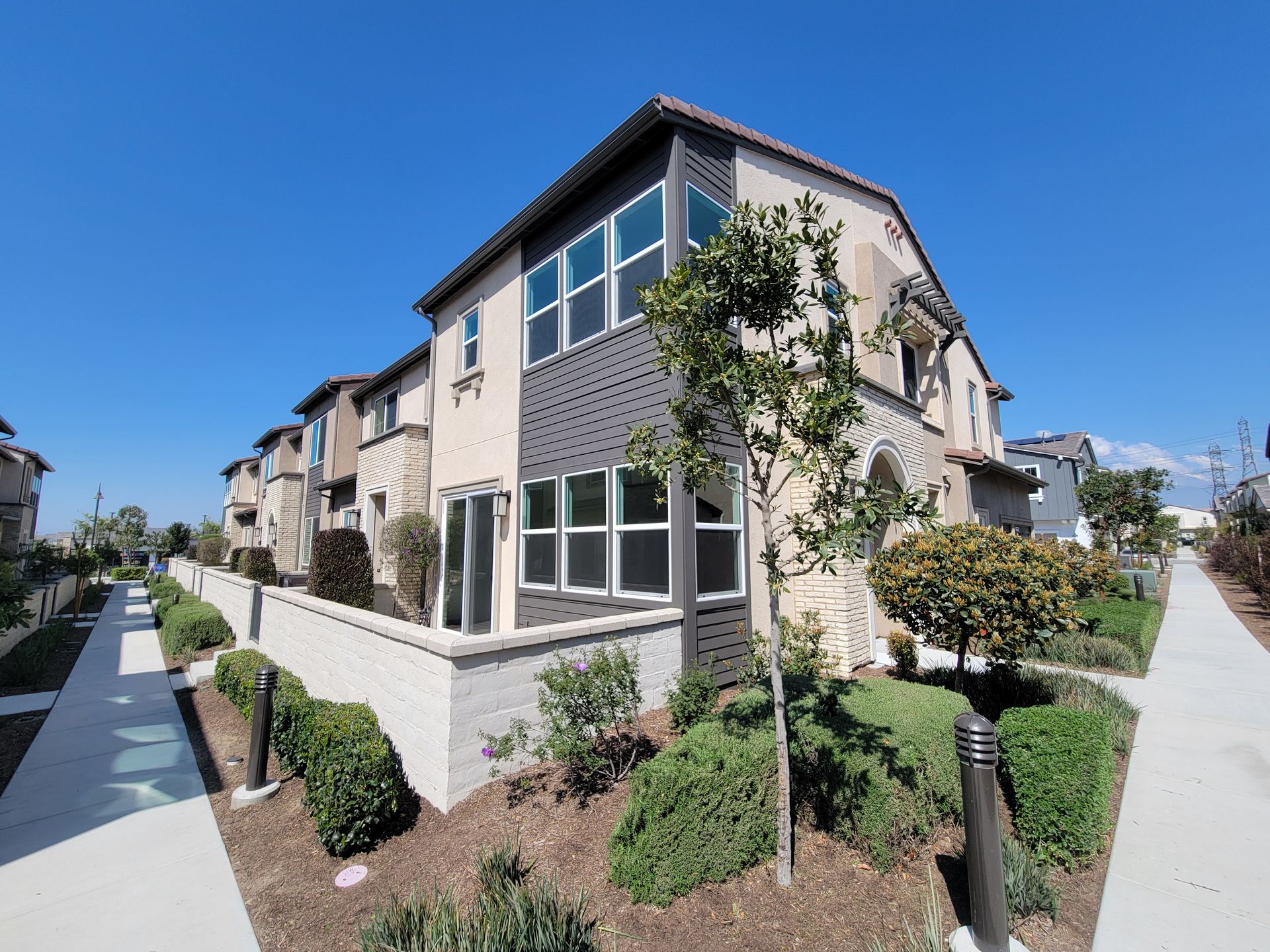 Photo showing a row of condominiums and their backyards