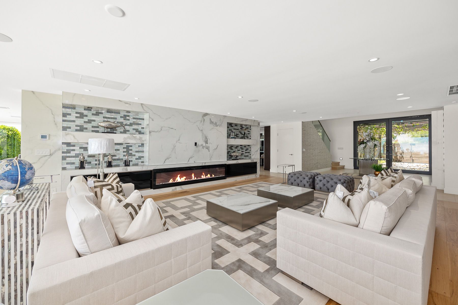 Photo showing a large living room space that has an open floor plan and a fireplace