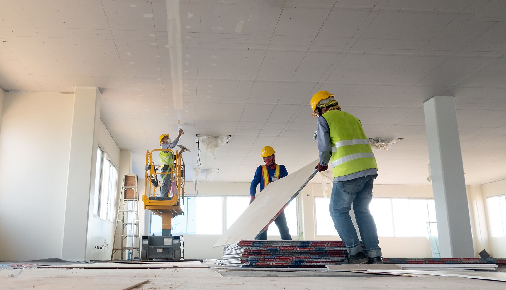 A group of construction workers are working on a building.